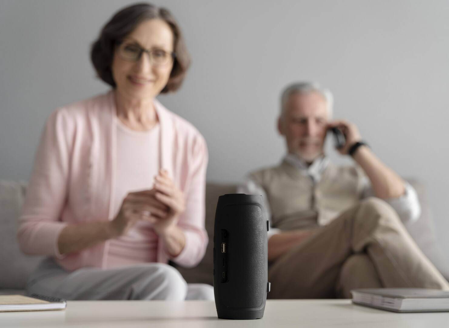 medium-shot-happy-couple-with-speaker-1